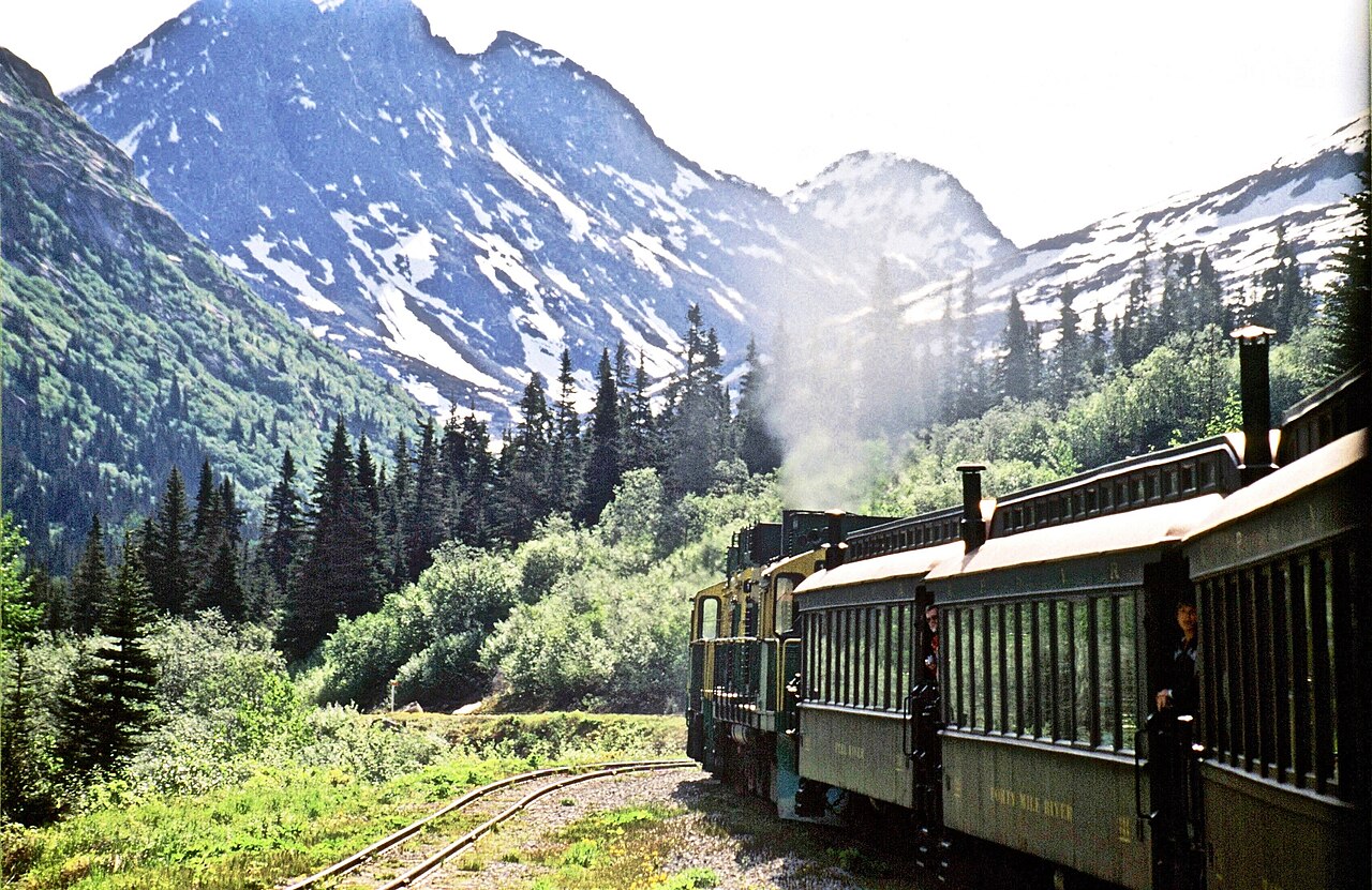 White Pass steam train rounding mountain cliff trestle